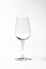 Empty clean wine glass on white gray background.