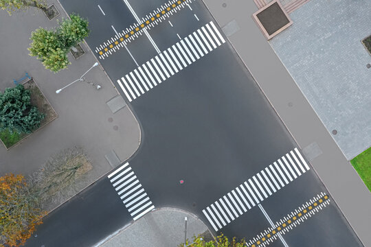 Aerial view of white pedestrian crossings on modern city street