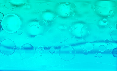 Blue glitter vintage lights background. Green texture background. Oil drops in water.