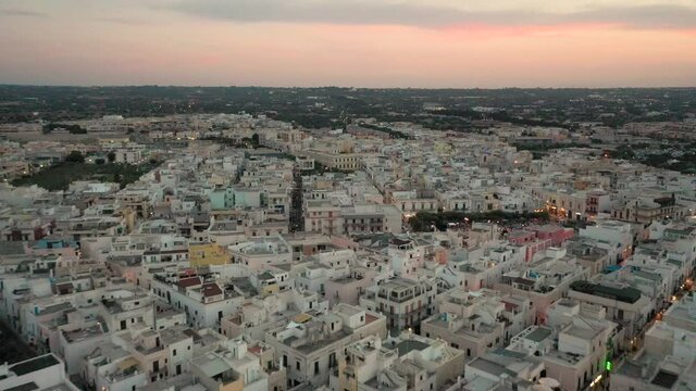 Polignano a Mare,Puglia,Bari,Italy.Beautiful 4K panoramic aerial video from flying drone to beach Lama Monachile,Polignano a Mare new and old city, Adriatic sea and Turquoise sea water at sunset (Seri