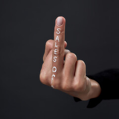 Hand of girl with middle finger having sales off writing