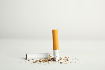 Broken cigarette on white table. Quitting smoking concept