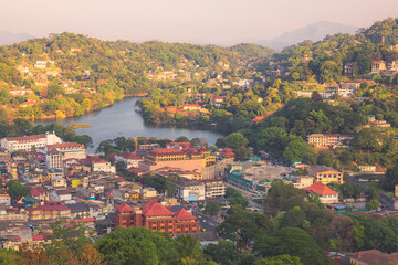 Cityscape view from Bahirawakanda with golden sunrise or sunset light of Kandy city, Kandy Lake and hill country in Sri Lanka.