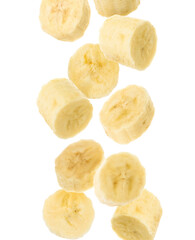 Slices of tasty ripe banana falling on white background