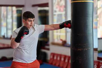 Overweight kickboxer working the heavy bag