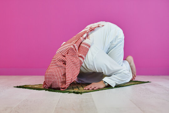 Young muslim man praying salat during Ramadan