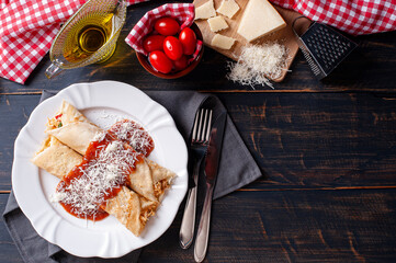 .Delicious chicken pancake stuffed with chicken and topped with tomato sauce and parmesan cheese....