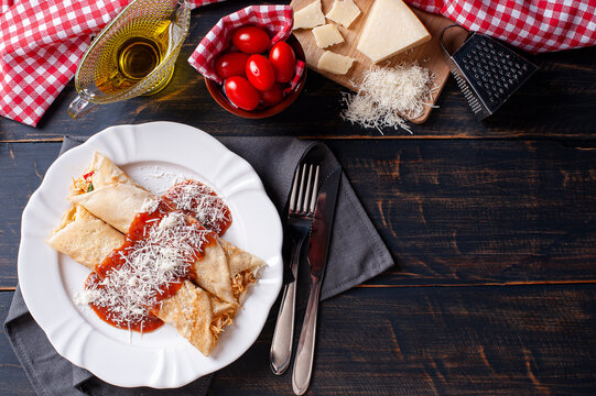 .Delicious Chicken Pancake Stuffed With Chicken And Topped With Tomato Sauce And Parmesan Cheese. Top View. Copy Space