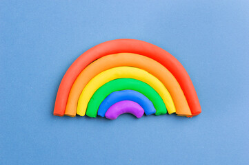 Plasticine rainbow on color background