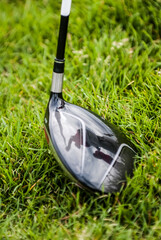 golfer's reflection on the golf club placing the ball for the initial hit