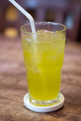 Iced green tea with a white straw