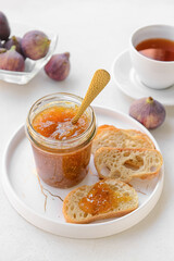 Composition with sweet fig jam on light background