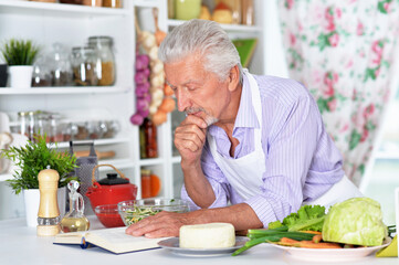 elderly  making salad  at kitchen