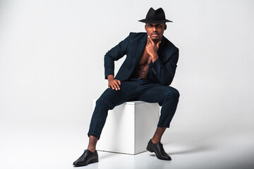 Portrait of an attractive, handsome, pretty and stylish businessman, African American model in a...