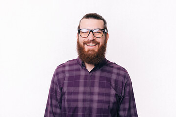 Portrait of bearded young man wearing eyeglasses and smiling