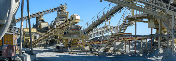 Panorama of conveyors and stone crushing and sorting machinery at gravel quarry
