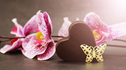 Close up image of heart shape chocolate with chocolates candies