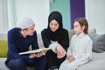 Young muslim family reading Quran during Ramadan