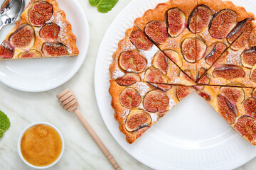 Plate with delicious fig pie on light background