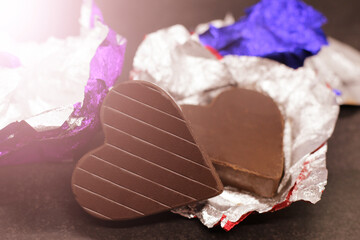 Close up image of heart shape chocolate with chocolates candies