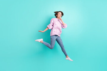 Full length photo of cute funny young woman wear violet sweater jumping ask not tell secrets isolated turquoise color background