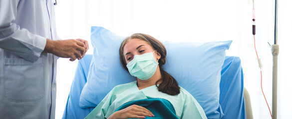 Naklejka premium Female patients wear a surgical face mask while being in hospital, coronavirus COVID-10 flu virus protection concept