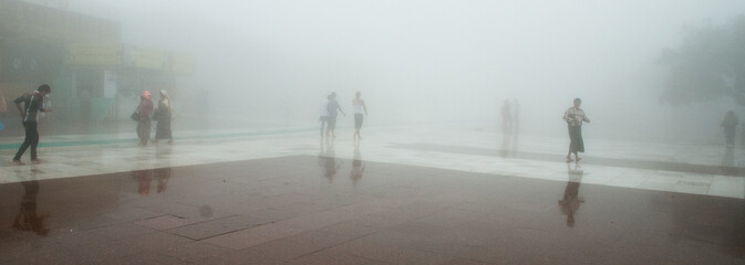 Obraz premium Pilgrims in the mist at the Golden Rock Temple, Myanmar (Burma), Asia