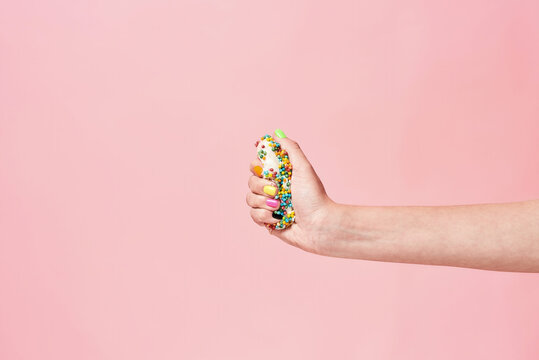 Say No To Sugar. Female Hand Squeezing Donut On Pink Background