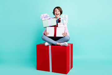 Photo of pretty adorable woman wear violet sweater sitting red gift holding stack presents space...