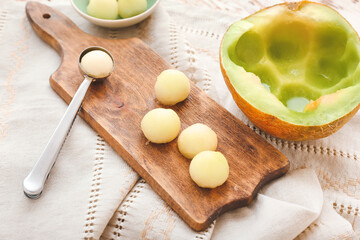 Composition with sweet melon balls on wooden background
