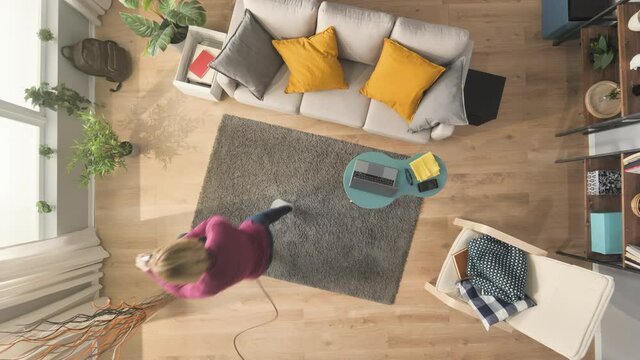 timelapse of woman cleaning the house using vacuum cleaner top down view,time lapse of young female doing housework in a modern apartment high angle view,housekeeping concept daylight shot