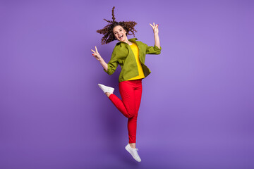 Fototapeta na wymiar Full size photo of young happy excited smiling cheerful girl show v-sign jumping isolated on purple color background