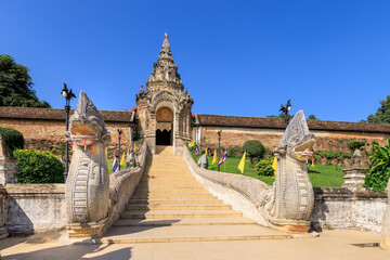 Gate and staircase to Wat Phra That Lampang Luang temple, famous tourist destination, Lampang province, Thailand - obrazy, fototapety, plakaty