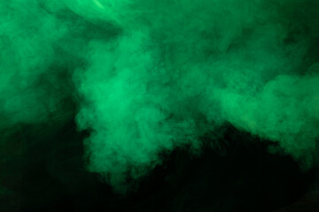 Fototapeta na wymiar Green smoke on black background