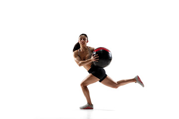 Fototapeta na wymiar Ball practice. Caucasian professional female athlete training isolated on white studio background. Muscular, sportive woman. Concept of action, motion, youth, healthy lifestyle. Copyspace for ad.
