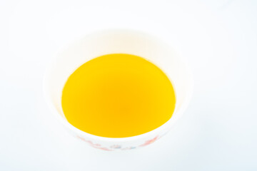 A bowl of golden chanterelles on white background