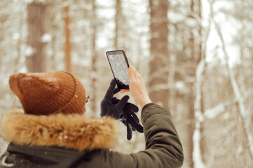 hand holding a phone. man take a photo on his phone
