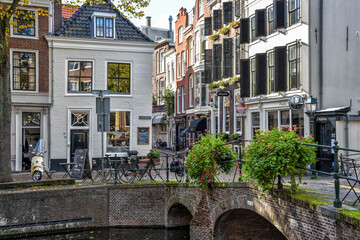 Near City center of The Hague., The Netherlands, Holland, Europe. Typical Dutch cityscape with a small brick bridge over a quiet canal where people park their bicycles during lunch. Holland, Europe