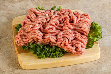 Raw pork minced meat over board