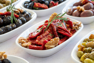 varieties of olives on the plate on a white background