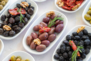 varieties of olives on the plate on a white background