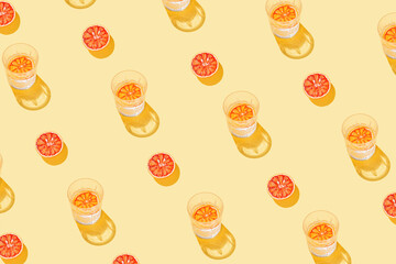 Creative pattern made with sliced grapefruit, blood orange and glass with lemonade or water on...