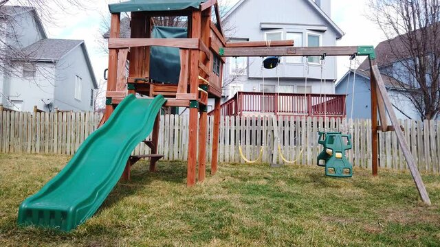Very windy day, swingset swings are blowing everywhere