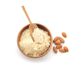Bowl and scoop with almond flour and nuts on white background