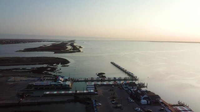 Stationary aerial view of marina, islands and the Gulf Intercoastal Waterway in Laguna Madre between North Padre Island and Corpus Christi Texas at sunset