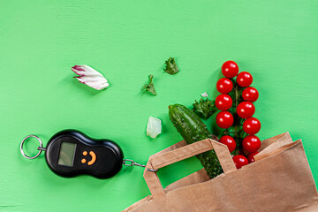 tomatoes, cucumbers, some lettuce, counterweight pulley and a paper bag on green background