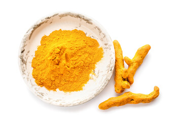 Bowl with turmeric powder and roots on white background