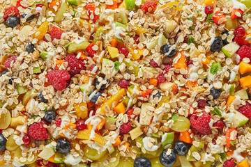 Background of assorted fruits and berries with muesli and yogurt