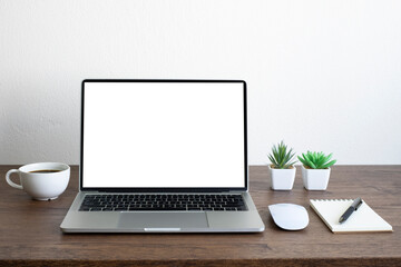 Fototapeta premium Laptop computer blank screen on wood office desk table with coffee cup and notebook, mouse computer with equipment office supplies. Business and finance concept. Workplace, Flat lay with copy space.