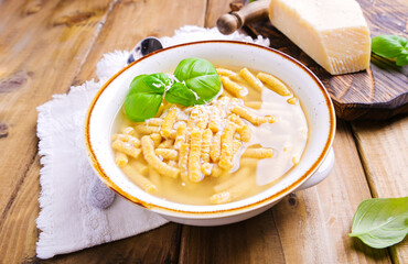 Passatelli in broth - pasta cooked in chicken broth. A pasta formed of bread crumbs, eggs, grated...